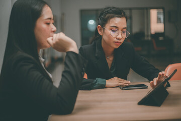 Businesswoman of senior management colleagues at meeting Professional businessmen work together on a SWOT analysis plan in a conference room via laptop.