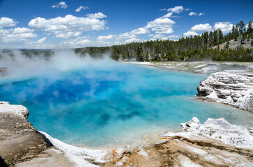 Steam rising from blue Excelsior Geyser Crater, Yellowstone National Park, Wyoming