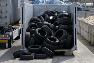 Recycling of old used car tires, pile of tires in the transport continent.