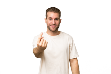 Young handsome caucasian man isolated on green chroma background doing coming gesture
