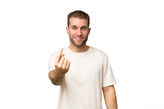 Young handsome caucasian man isolated on green chroma background doing coming gesture