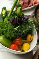 Fresh vegetable salad with tomato, cucumber and greens
