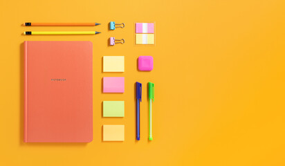 Banner with orange notebook and colorful stationery on yellow background. Flatly, copyspace.