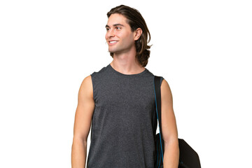 Young sport handsome man isolated on green chroma background looking side