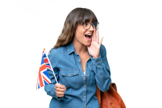 Young caucasian woman holding an United Kingdom flag over isolated background shouting with mouth wide open to the side