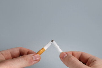 Hand breaks cigarette, quit smoking concept