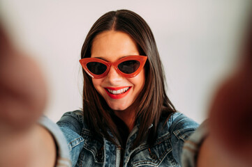 Close up of beautiful woman taking photo with smartphone, selfie.