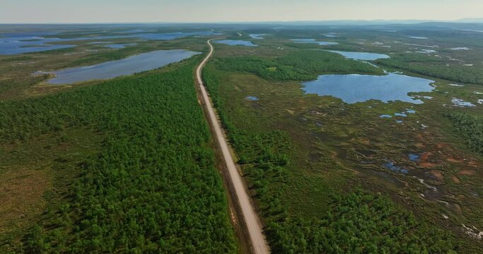 Aerial view of a remote road in middle of pools and wetlands, summer in Kevo wilderness of Lapland
