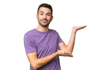 Young handsome caucasian man over isolated background extending hands to the side for inviting to...