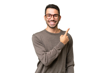 Young handsome caucasian man over isolated background pointing to the side to present a product