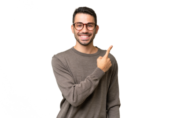 Young handsome caucasian man over isolated background pointing to the side to present a product