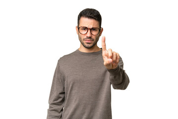 Young handsome caucasian man over isolated background counting one with serious expression