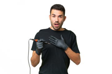Tattoo artist caucasian man over isolated background surprised and shocked while looking right