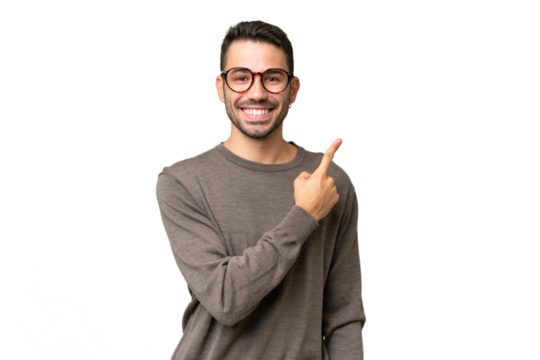 Young handsome caucasian man over isolated background pointing to the side to present a product