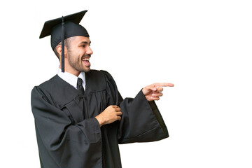 Young university graduate man over isolated background pointing finger to the side and presenting a...