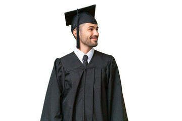 Young university graduate man over isolated background looking side