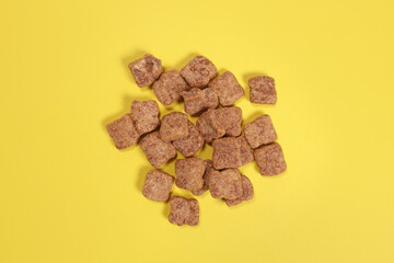Chocolate snacks, dry breakfast on yellow background
