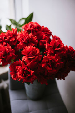 Bucket full of red reflexed roses, vertical image 