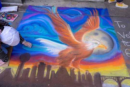 Knoxville, TN, USA 4-1-23: Dogwood chalk walk festival with many artists creating chalk art on the sidewalks.  Beautiful colors and room for copy space.  Street art.