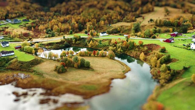 A miniaturized village, farms, and farm fields on the shore o the fjord