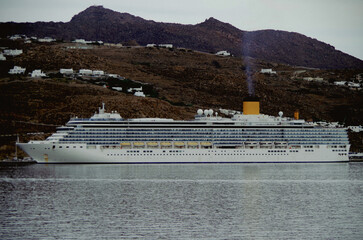 Modern white cruiseship or cruise ship liner Deliziosa in port of Mykonos, Greece during...