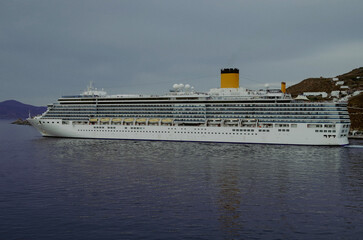 Modern white cruiseship or cruise ship liner Deliziosa in port of Mykonos, Greece during...