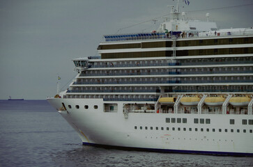 Modern white cruiseship or cruise ship liner Deliziosa in port of Mykonos, Greece during...
