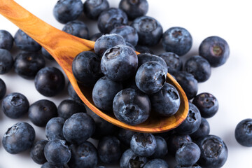 Fresh blueberries in wooden spoon