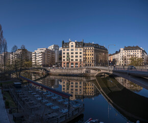 Obraz premium Office building between two bridges over the canal Karlbergskanalen, a sunny spring day in Stockholm