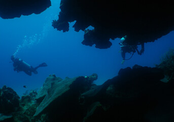 a diver exploring a cave in the caribbean sea