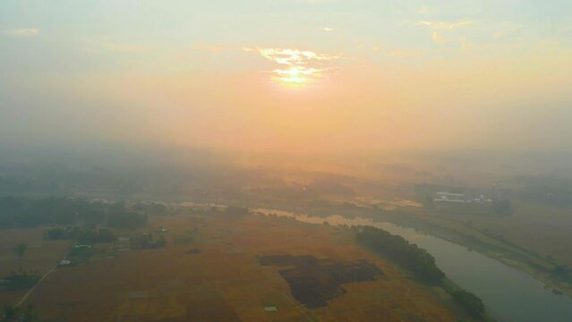 Sunrise on a hazy morning over the Surma River in Bangladesh