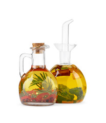 Different sorts of cooking oil with spices and herbs in bottles on white background