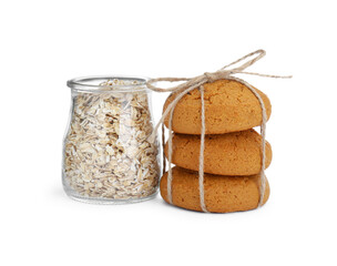 Delicious oatmeal cookies tied with twine and flakes on white background