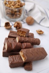 Pieces of different tasty chocolate bars on white table
