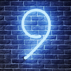 Glowing neon number 9 sign on brick wall