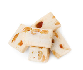 Many pieces of delicious nougat on white background, top view