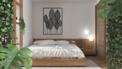 Jungle frame, biophilic concept idea interior design. Tropical leaves over japandi bedroom with wooden bed. Cerpegia woodii and monstera deliciosa plants
