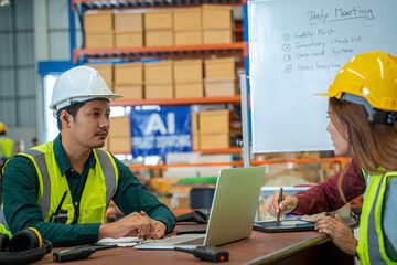 Logistics workers have a meeting in a large distribution warehouse,Logistic industry concept.