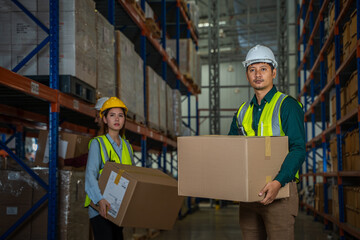 Warehouse worker checking goods and supplies on shelves with goods background in warehouse,Logistic and business export.