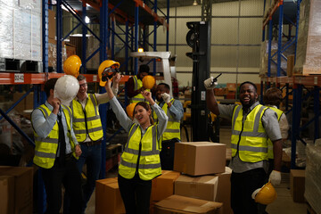 Successful warehouse team smiling happily,Cheerful logistics workers in a large distribution warehouse,Logistic and business export,Industrial and industrial workers concept.