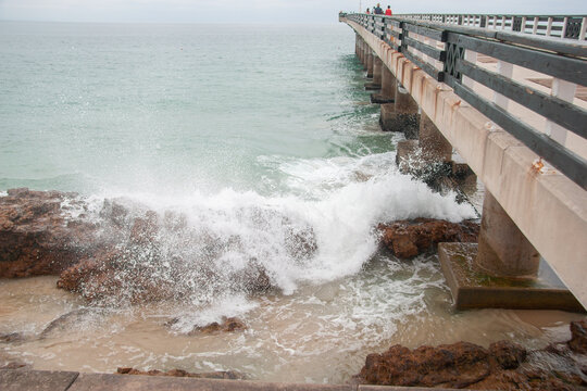 Wide angle: waves crash onto rocks below Shark Rock Pier in Port Elizabeth