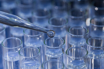 Pipette dropping fluid into test tube
