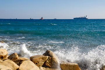 Foamy waves splashing at rocky coastline in Limassol, Cyprus
