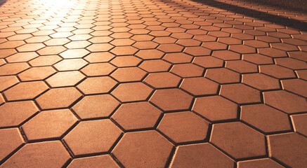 Hexagon Brown Cobblestone Pavement in vintage style with Golden Sunlight and Shadow on Surface