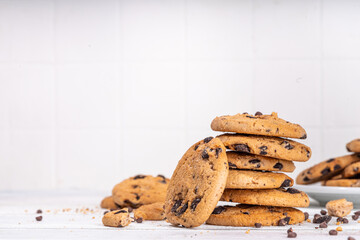 Stack and plate of chocolate chips cookies. Traditional american chocolate drops crisp cookies on...