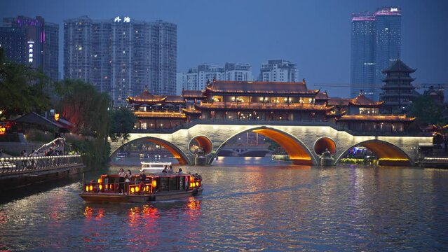 The beautiful view of Jinjiang Anshun Covered Bridge Tourists take a boat to visit the city scenery