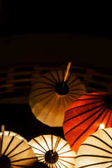 Festive asian multi colored umbrellas on black background