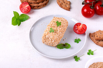 Caboc, Scottish soft cheese made of fat milk, in oat grains served on the plate