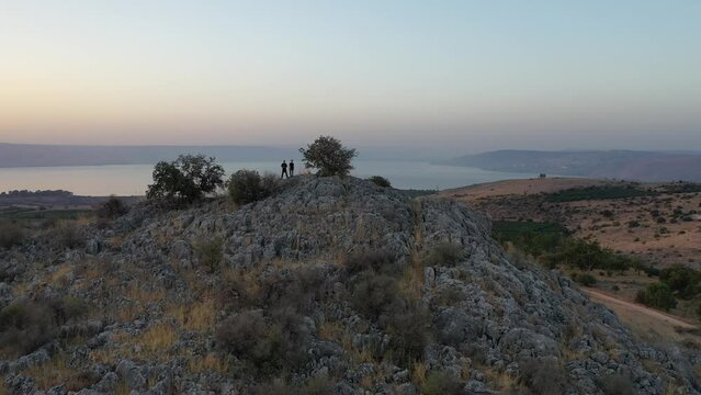 sunrise over the golan heights and lake of galilee in israel. drone flying over a hill in the galilee towards the sunrise. morning views of the sea of galilee from the air. israeli sunrise.