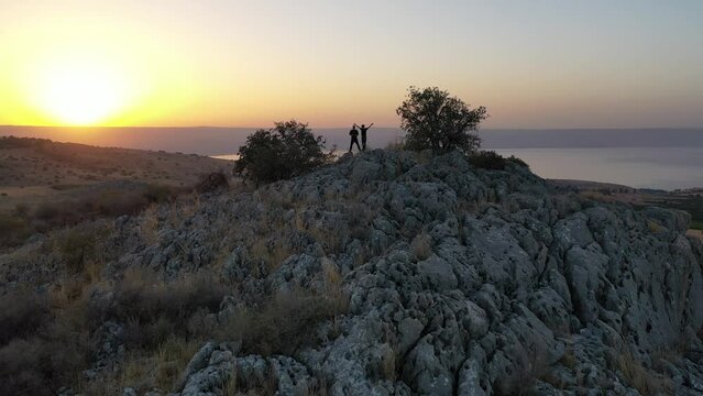 sunrise over the golan heights and lake of galilee in israel. drone flying over a hill in the galilee towards the sunrise. morning views of the sea of galilee from the air. israeli sunrise.